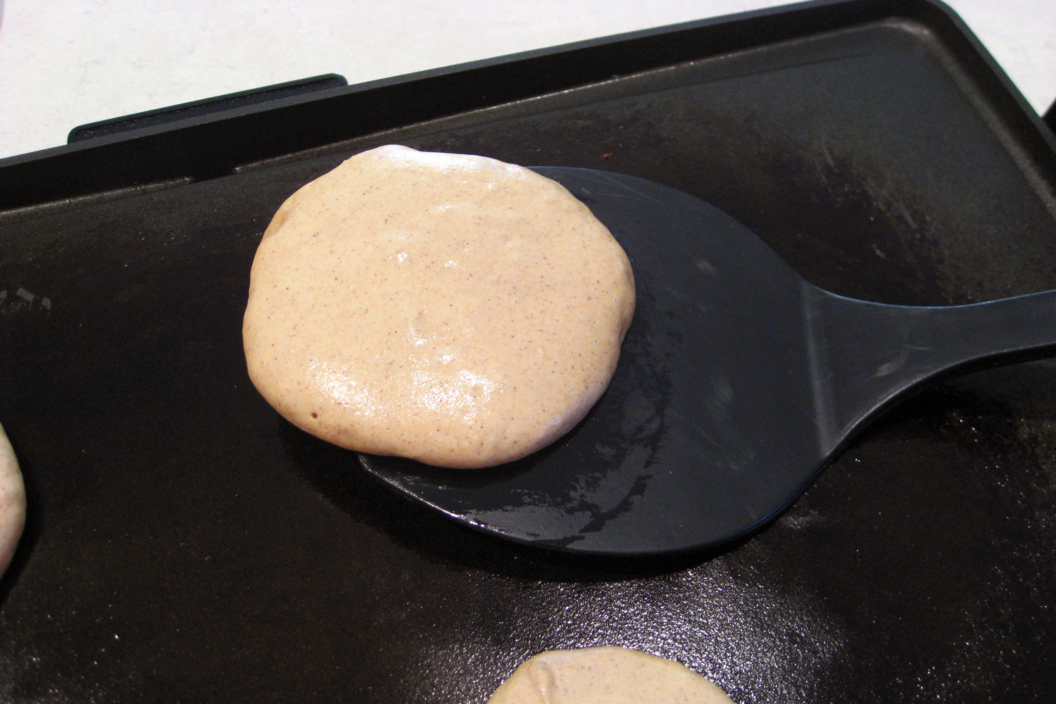 flipping quinoa pancakes