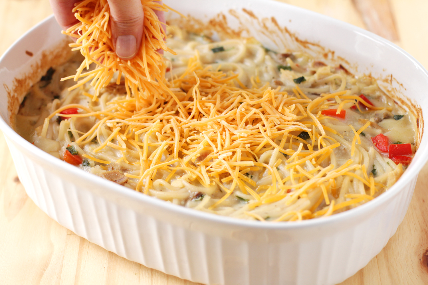 Sprinkle cheese on casserole