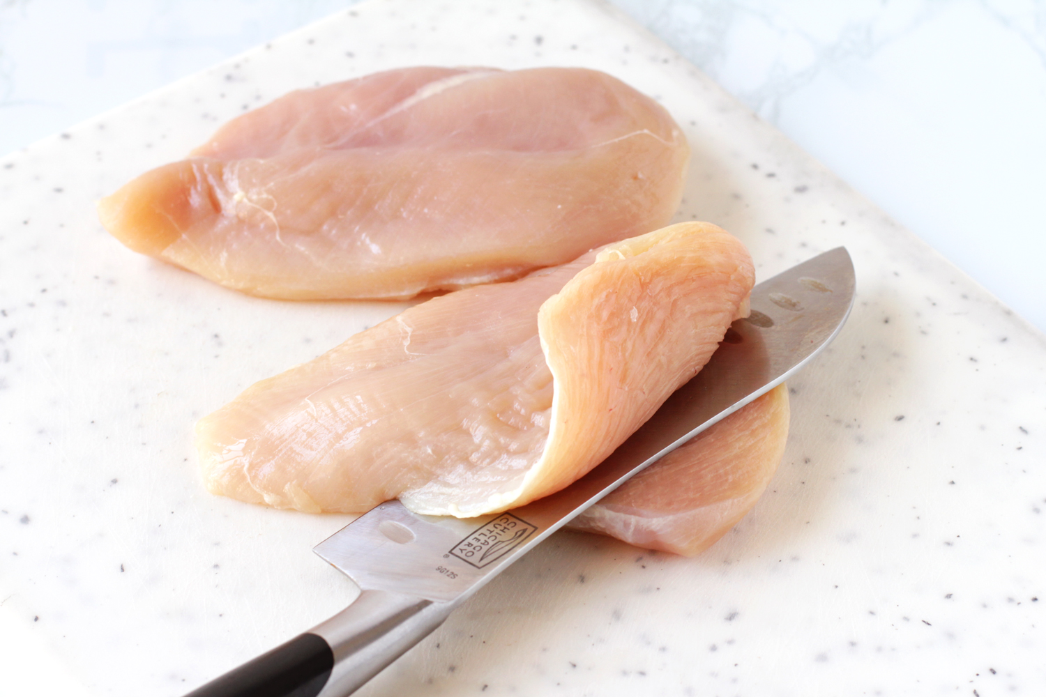 slicing chicken breasts into fillets