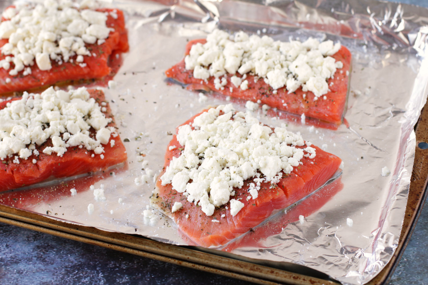 Salmon topped with feta cheese